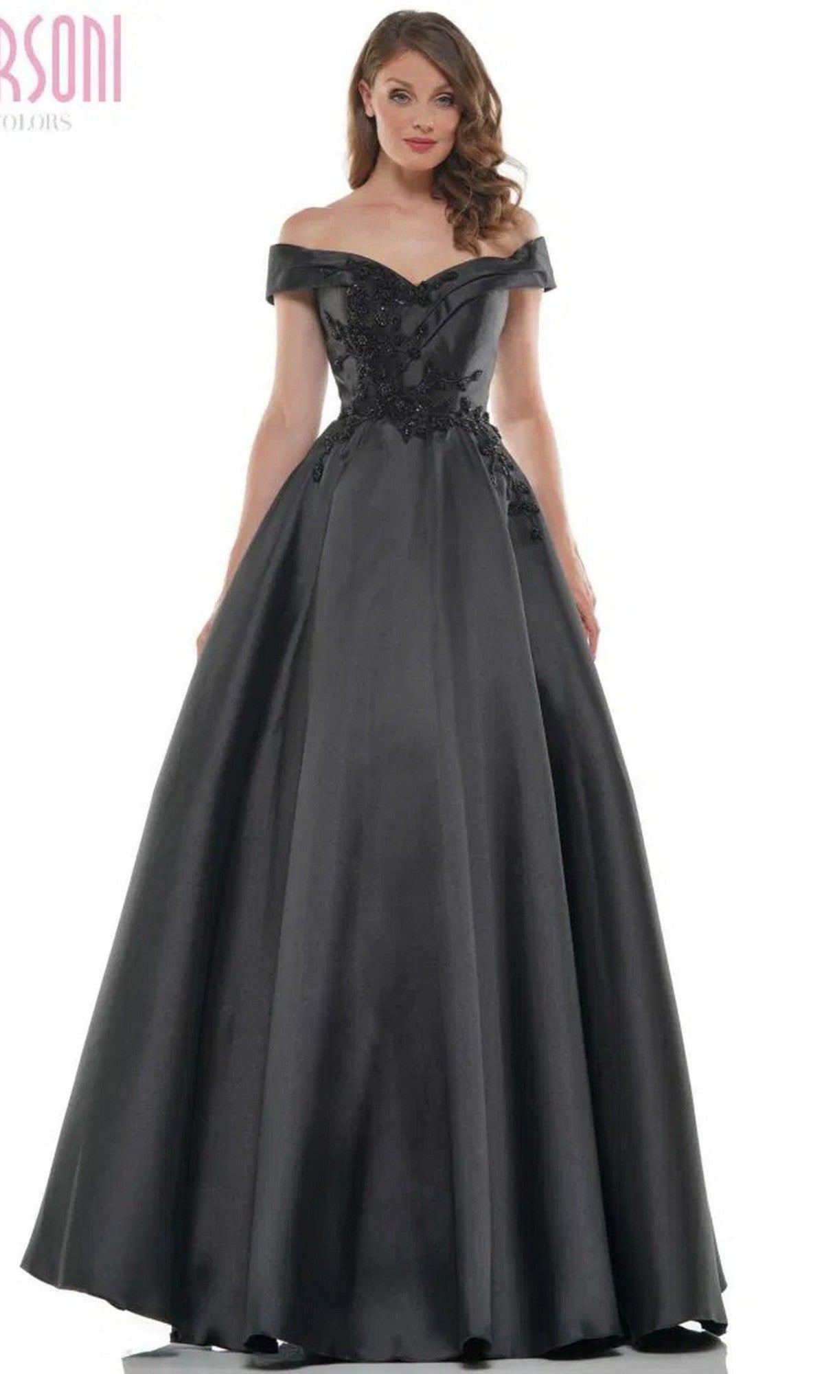 A woman in the Marsoni MV1008 long formal dress—a black, off-the-shoulder, floor-length ball gown with a fitted bodice, flared skirt, and an elegant silhouette.